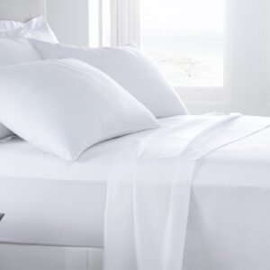 Full Fitted Hotel Sheet 54x75x12 - Pacific Hotel Supplies Inc. Hotel bed with white sheets and pillows