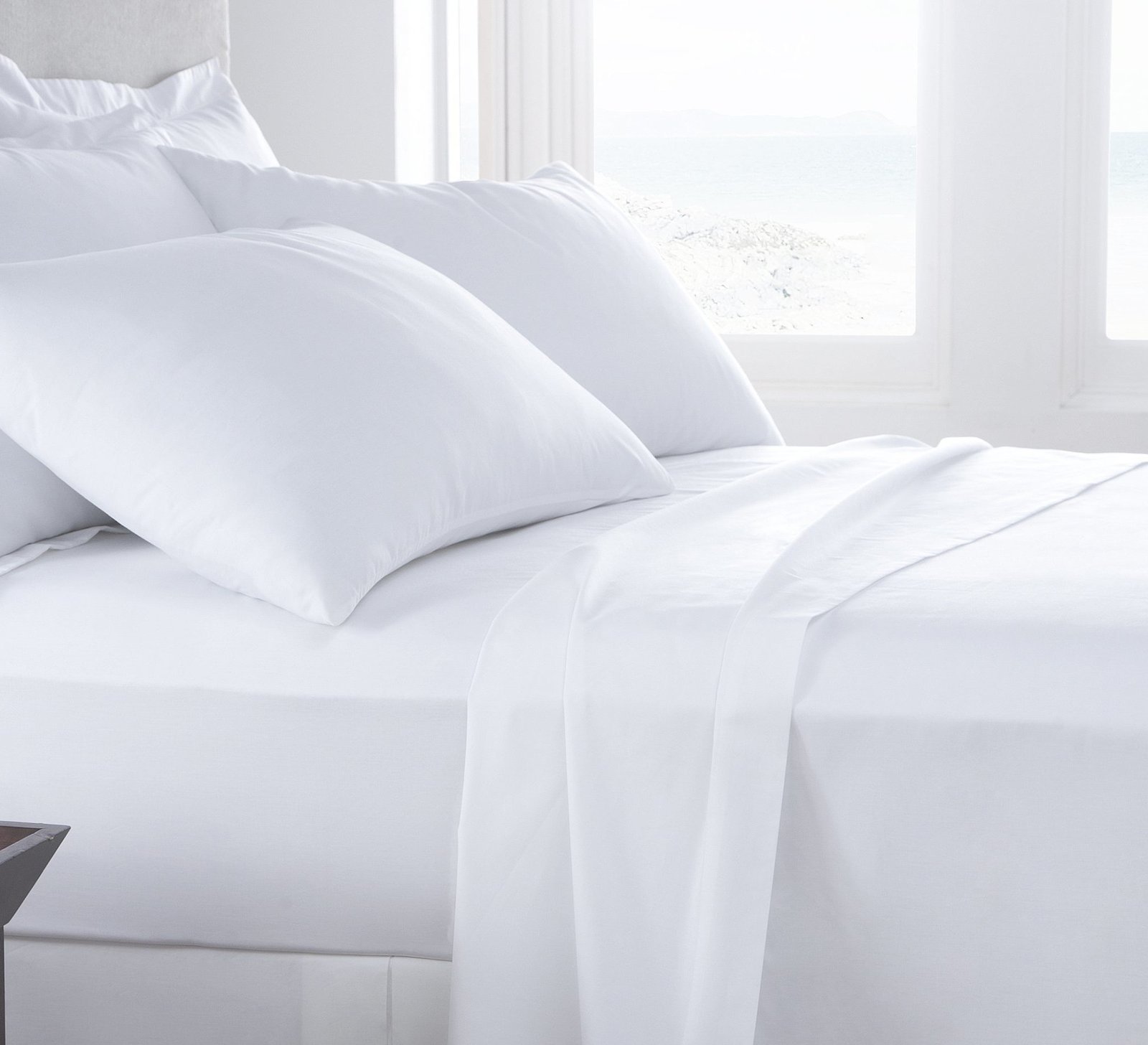Full Fitted Hotel Sheet 54x75x12 - Pacific Hotel Supplies Inc. Hotel bed with white sheets and pillows